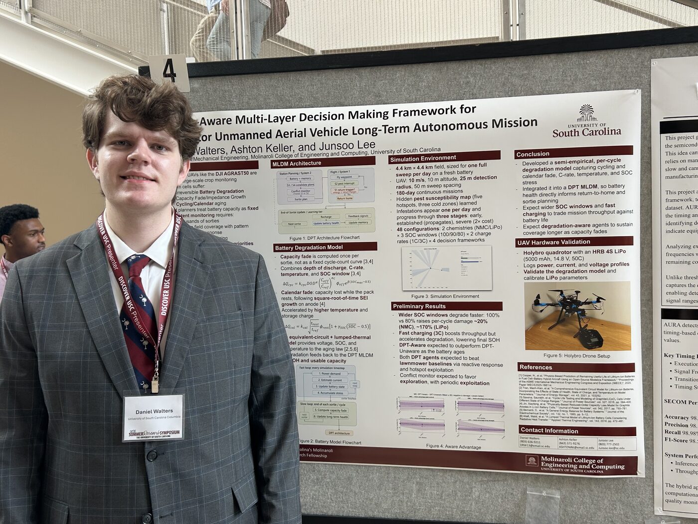 Dan Walters standing beside his research poster at the 2026 Summer Research Symposium